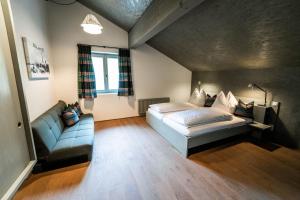 a bedroom with a bed and a couch at FAT Mankei in Seidlwinkl