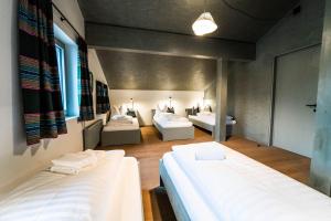 two beds in a room with two beds sidx sidx sidx sidx at FAT Mankei in Seidlwinkl +3 photos