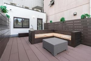a wooden bench sitting on a patio in a building at The Mita Villa - 2 bed rooms & 3 floors villa with roof garden in Tokyo +49 photos