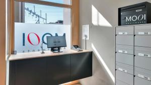 a desk with a computer on top of it at MOOI Apartments Biel in Biel +72 photos