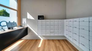 a room with white cabinets and a desk with a computer at MOOI Apartments Biel in Biel