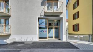 an entrance to a building with a mno sign on the door at MOOI Apartments Biel in Biel