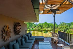 a living room with a couch on a deck at Amaaranth Goa in Varca