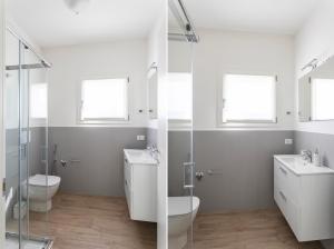a bathroom with two sinks and a toilet at Maison Bellini 4 in Toscolano Maderno +40 photos