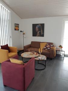 a living room with two couches and a table at Ferienhaus Happy Days in Nordhorn