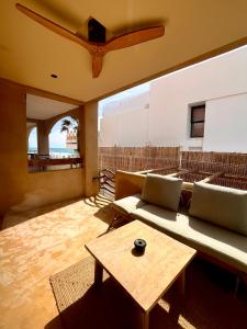 a living room with a couch and a table at Apartamentos Flores playa in La Mata