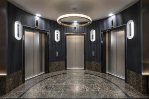 a elevator lobby with doors and a chandelier at Radisson Blu Royal Hotel, Helsinki in Helsinki