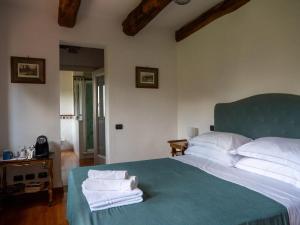 a bedroom with a bed with towels on it at Città della Pieve Retreat in Città della Pieve +19 photos