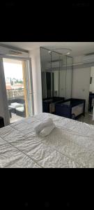 a bedroom with a white bed with a mirror at Droit au but!! in Marseille