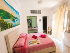 a bedroom with a bed with a red blanket at Anna e Augusto B&B --Embrace the world--4-minute walk from the Old Town丨Authentic local experience丨English-speaking staff and Wi-Fi - free shuttle to the station in Lucera