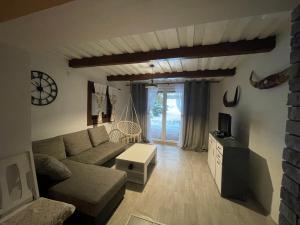 a living room with a couch and a table at Chalupa Lipka in Kolárovice