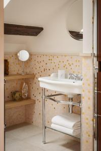 a bathroom with a sink and a shelf with towels at La Bohème Montmartre - Studios & Apartments de luxe au Sacré Coeur in Paris