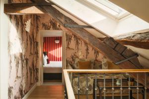 a room with a attic with a bed in it at La Bohème Montmartre - Studios & Apartments de luxe au Sacré Coeur in Paris