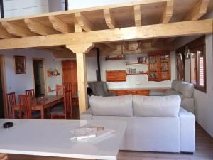a living room with a couch and a table at Casa Abuela Antolina in La Horcajada