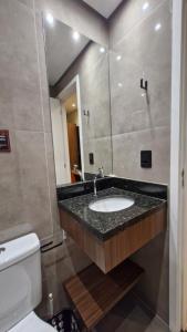 a bathroom with a sink and a toilet at Nexus Conceição in São Paulo +82 photos