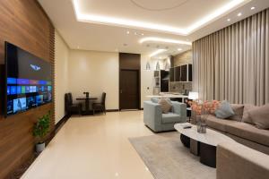 a living room with a couch and a table at Topaz Serviced Apartments in Riyadh