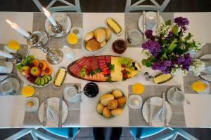 a table filled with food and fruit on a table at Landhaus Elbeflair bei Dömitz in Lenzerwische