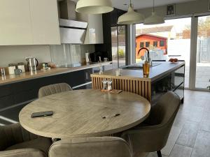 a kitchen with a wooden table and chairs at Cozy Room at Willow House in Leyland