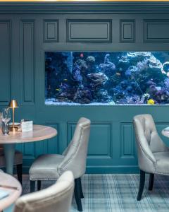 an aquarium in a restaurant with a table and chairs at Vaughans Anchor Inn in Liscannor
