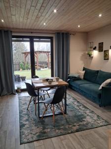 a living room with a table and a couch at Domki i tyle in Rabka-Zdrój