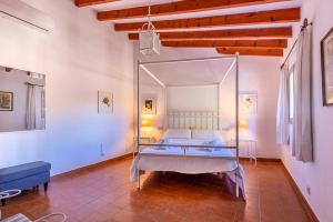 a bedroom with a bed with a mirror in it at Villa Rafaleta by Villa Plus in Pollença
