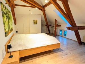a bedroom with a large bed in a room with wooden beams at Loft in Weiler in Weiler +12 photos