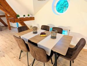 a dining room with a wooden table and chairs at Loft in Weiler in Weiler