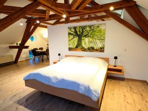 a bedroom with a bed and a painting on the wall at Loft in Weiler in Weiler