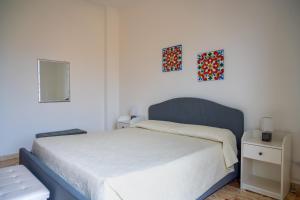 a bedroom with a bed and two pictures on the wall at Da DOMITILLA in centro storico con panorama in Avola +19 photos