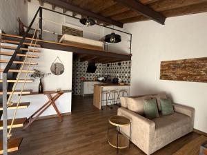 a living room with a loft bed and a couch at Casa Rama D Oliveira in Barrada