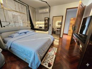a bedroom with a large bed and a mirror at The Lakeside Sanctuary in Ban Mae Cho +15 photos