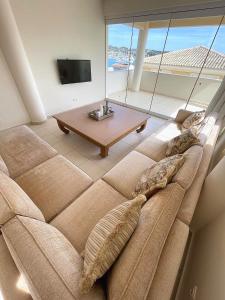 a large couch in a living room with a table at PH Marina Apartments in Porto Heli