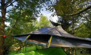 a tent is set up in a forest at Robinzonski kamp Žumberak in Grabar