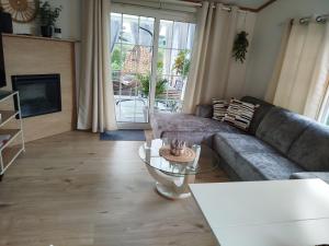 a living room with a couch and a table at Chalet-Urlaubsglück am See in Lathum