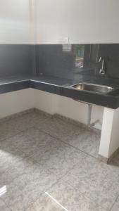 a kitchen counter with a sink and a tile floor at Landmark Residency in Atirāmpattinam