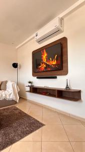 a living room with a fireplace on the wall at Modern Flat in Khouribga in Khouribga