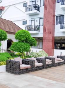 a row of chairs in front of a building at Chill Studio w Balcony & Free Pool Lapu-Lapu in Mactan Island