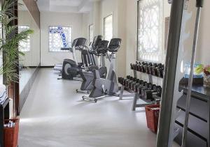 a gym with treadmills and ellipticals in a room at Sedra Al Alami Jeddah in Jeddah