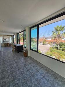 a room with large windows and a view of the ocean at Pool Villa 25 in Ban Nong Pru