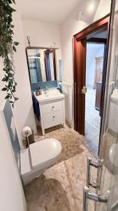 a bathroom with a sink and a toilet and a mirror at Ferienwohnung Moselblick in Alf +37 photos