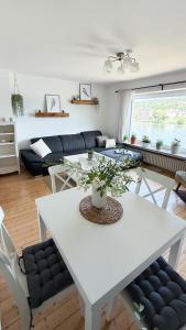 a white table and chairs in a living room at Ferienwohnung Moselblick in Alf