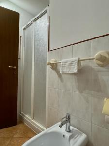 a bathroom with a white sink and a shower at Sole & Mare in Montesilvano