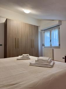 a bedroom with a bed with three towels on it at Sole & Mare in Montesilvano