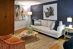 a living room with a couch and a table at Mirabelle Guesthouse in Franschhoek