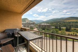 a balcony with a table and chairs and mountains at Seasons at Avon, A Vail Resorts Property in Avon