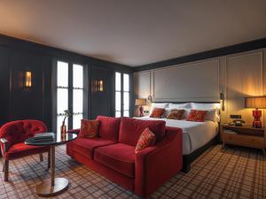 a hotel room with a red couch and a bed at Wittmore Hotel GL- Adults Only, Small Luxury Hotels in Barcelona +59 photos