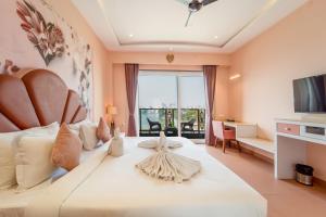 a bedroom with a large white bed with a large window at Lakeside Leisure A Lake View Hotel in Udaipur