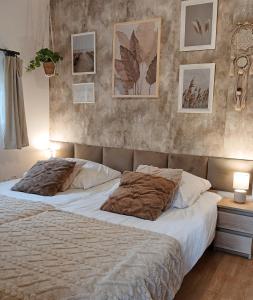 a bedroom with two beds and pictures on the wall at Eleonor Accommodation exclusive house in Liszki
