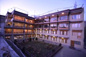 a large building with a courtyard in front of it at Hotel Latso Ladakh in Leh