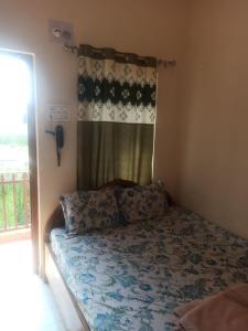 a bedroom with a bed with a curtain and a phone at Hotel Vishwa Residency in Patna +10 photos